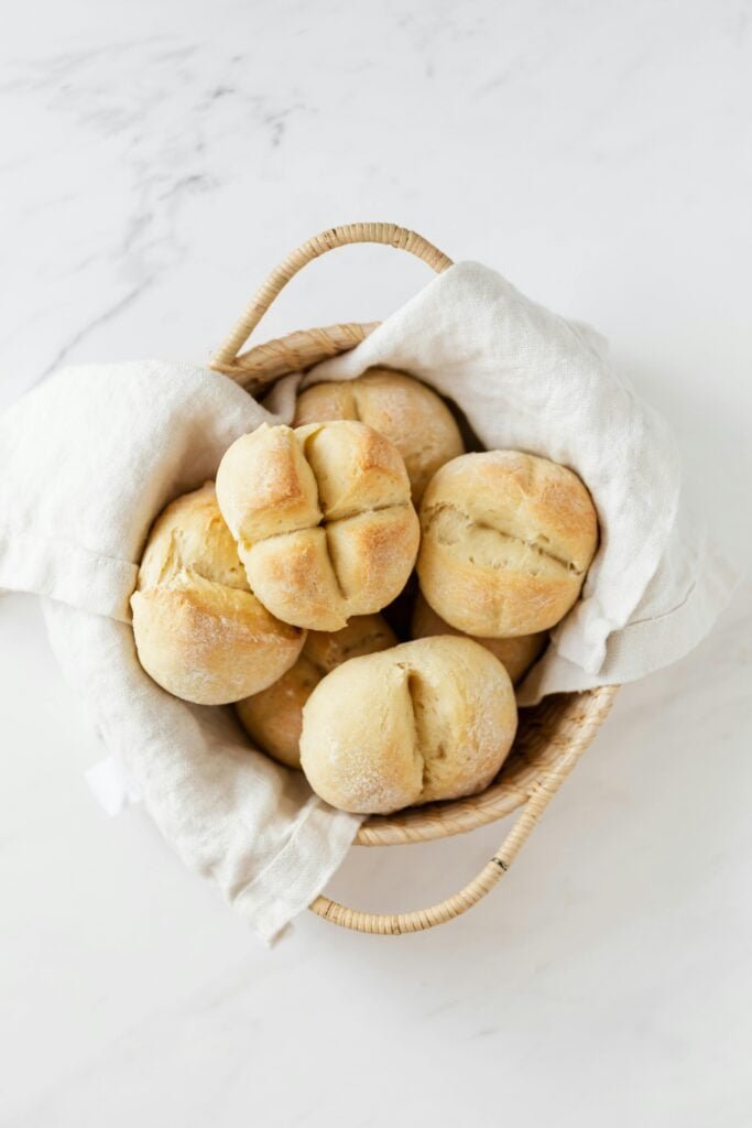 Gluten Free Bread rolls displayed in a linen lined woven basket