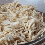 Crockpot Shredded Chicken in a glass bowl.