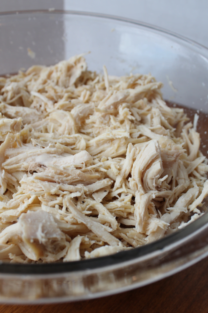 Crockpot Shredded Chicken in a glass bowl.