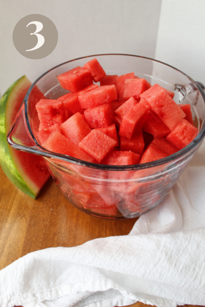 Cut watermelon chunks in a glass mixing bowl.