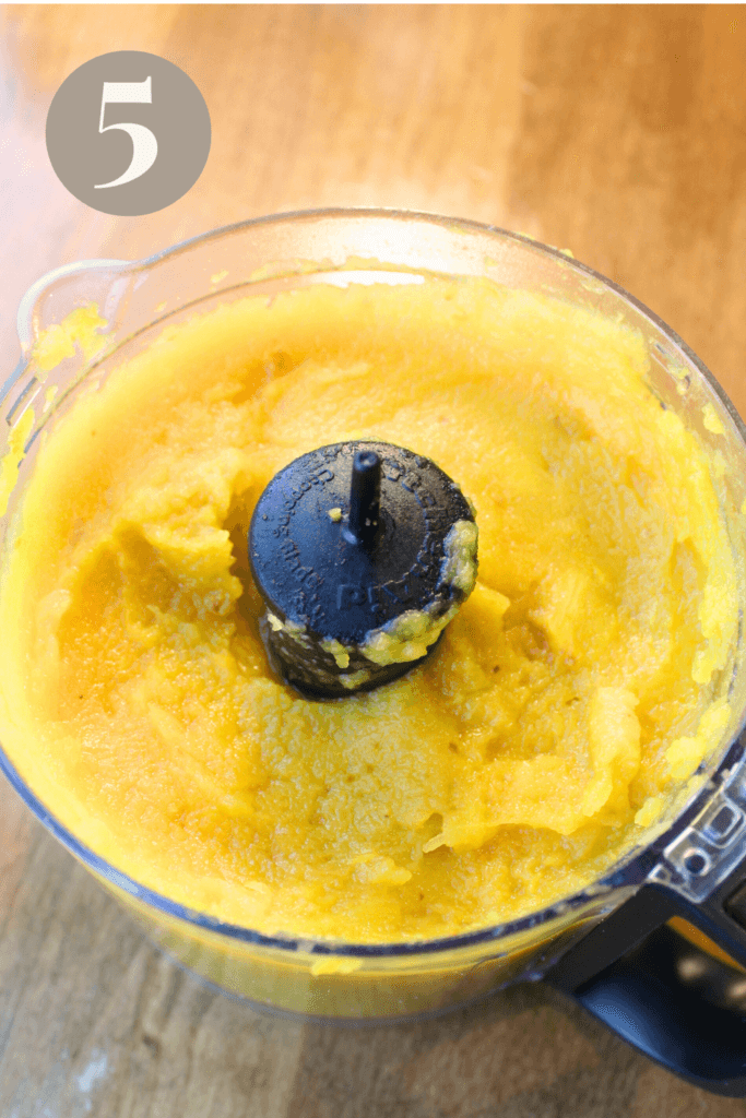 Pumpkin puree in a food processor on the counter.