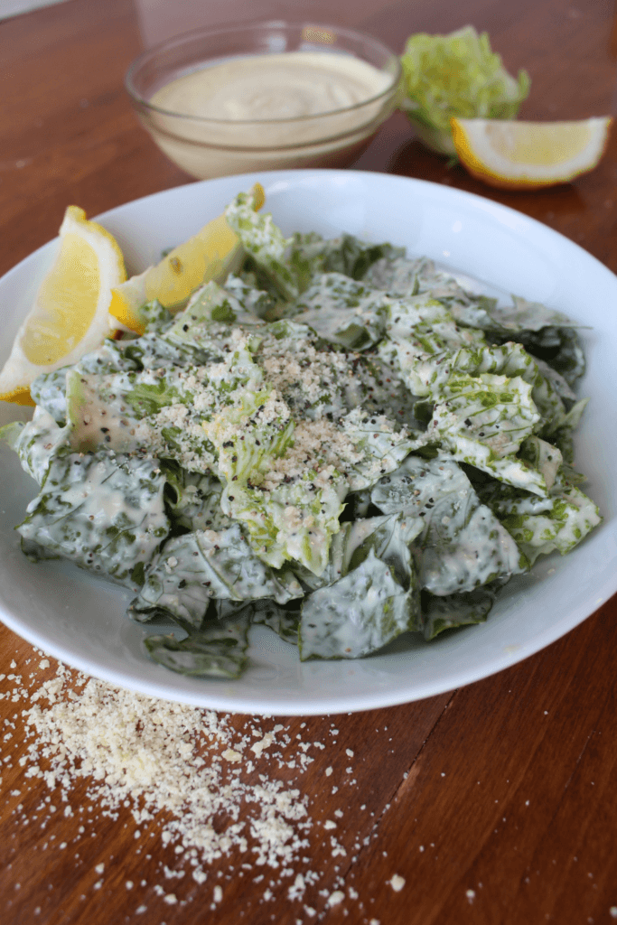 Mixed caesar salad on a wood table.