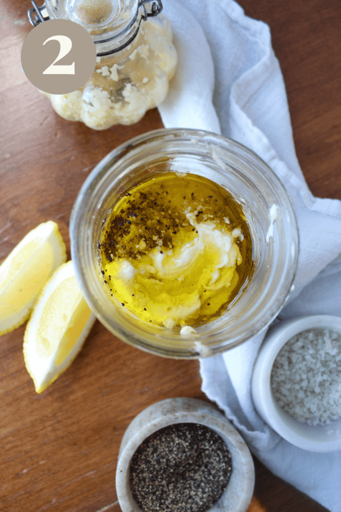 Caesar dressing ingredients in a jar unmixed.