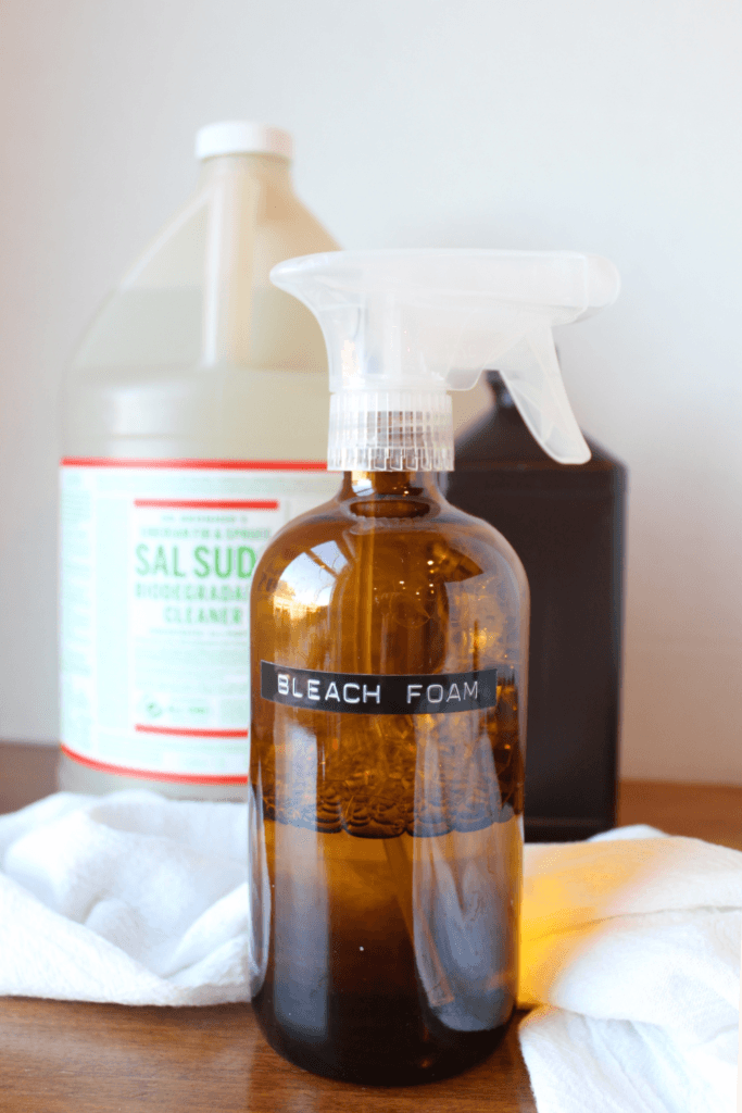 Foam bleach spray, sal suds, and hydrogen peroxide on a table.