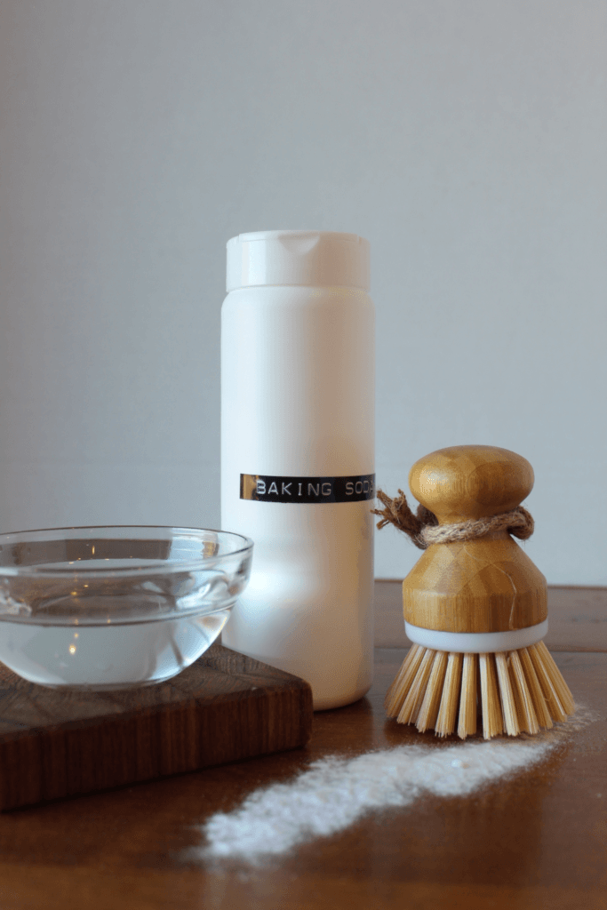 Gentle scrub cleaner on counter with brush and baking soda.