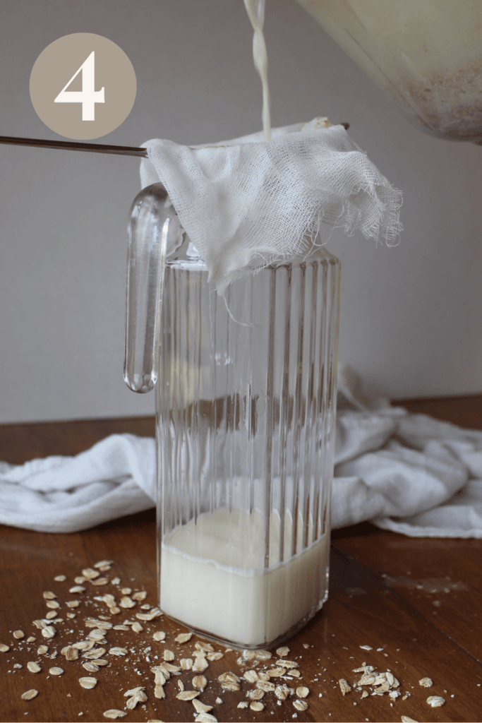 Oat milk being poured into a glass pitcher through a cheese cloth and a colander.