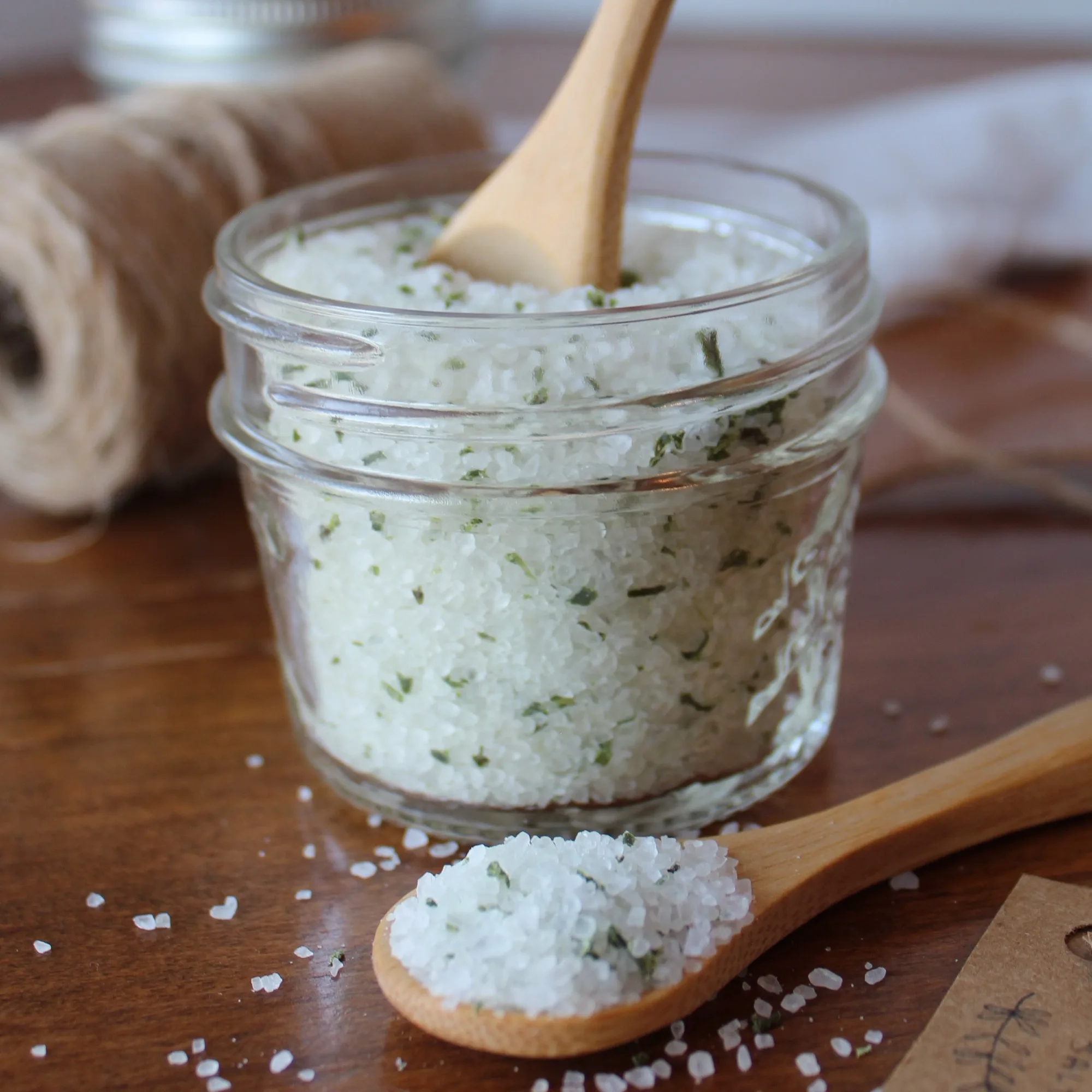 Rosemary salt in a mason jar sitting on the counter with some string.