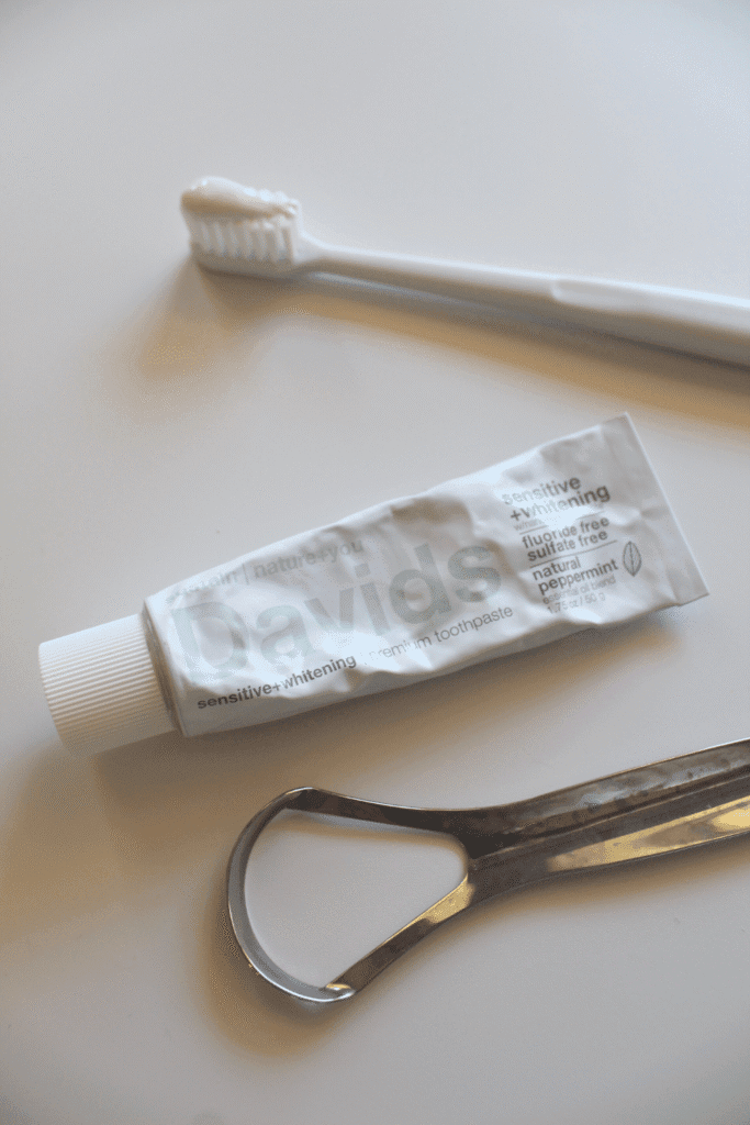 Natural toothpaste, toothbrush and tongue scraper.